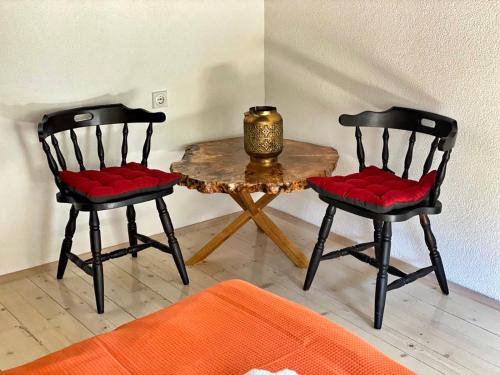 two chairs and a table with a candle on top at House of Sokolovi Kratovo in Kratovo