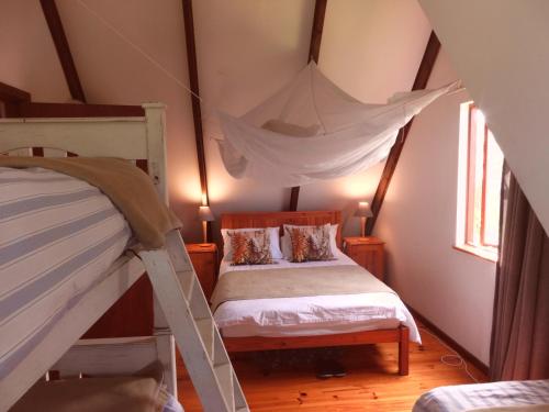 a bedroom with two bunk beds in a attic at Ashanti House - Living The Breede in Malgas