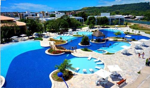 a large pool with blue water in a resort at Iloa Apartamento Lindo in Barra de São Miguel