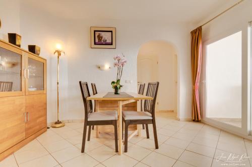 a dining room with a table and chairs at Sobre de Granadella Haus 5 in Jávea