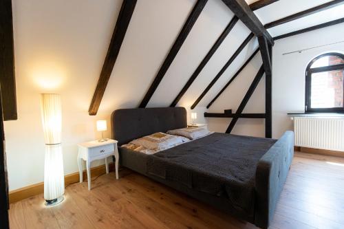 a bedroom with a bed and two lamps in a room at Alte Schule Spittelstein 1OG links in Rödental