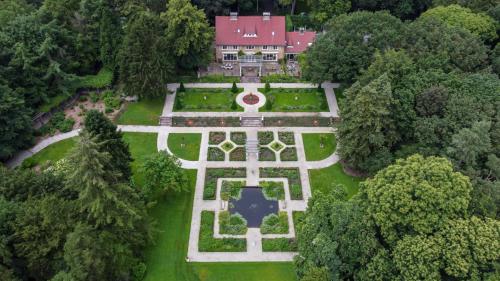 an aerial view of a mansion with a garden at Amsterdamgarden - stunning garden villa with pool close to Amsterdam in Laren
