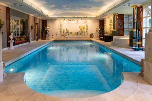 an indoor pool with blue tiles in a house at Amsterdamgarden - Nardinclant - Laren NH in Laren