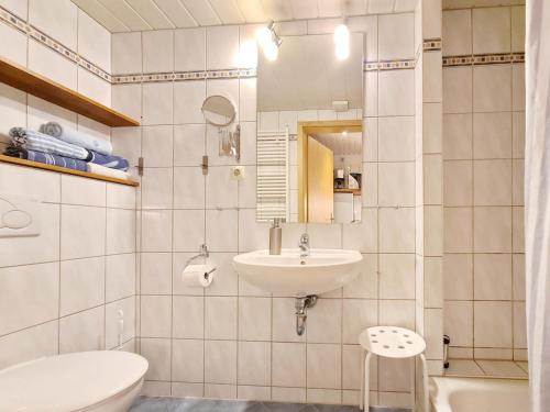 a white bathroom with a sink and a toilet at RosenGärtchen in Vadersdorf
