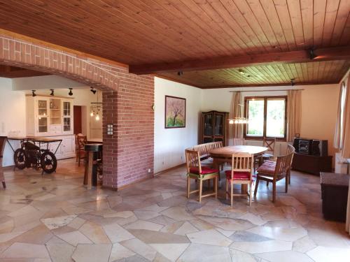 a large living room with a table and chairs at Villa Leone in Maria Rain