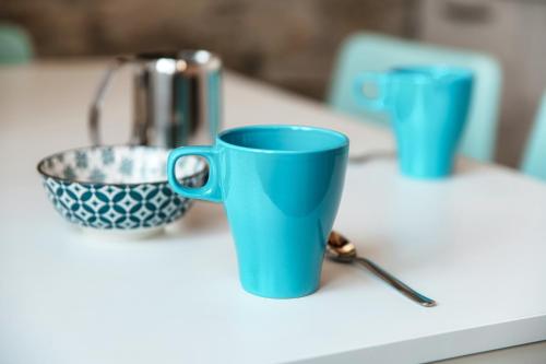 two blue cups sitting on top of a counter at Spazio 77 - The House Of Travelers in Como