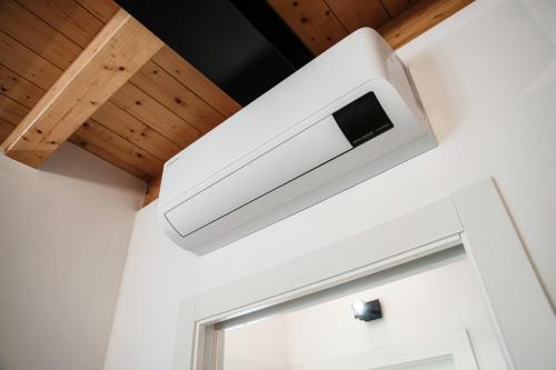 a white microwave oven hanging from a ceiling at Spazio 77 - The House Of Travelers in Como