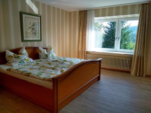 a bed in a room with a large window at Burgblick-Fewo Töpfer in Annweiler am Trifels