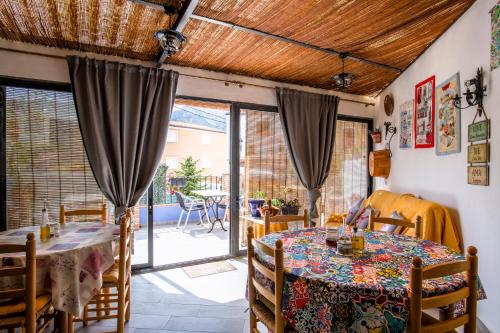 a dining room with a table and chairs and a patio at Hotel Casa Pilar Adults Only in Castell de Castells