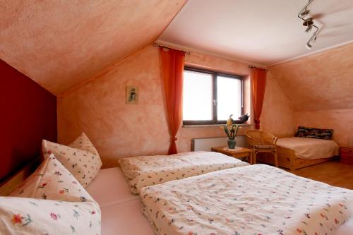 a bedroom with two beds and a window at Storchennest - 58270 in Süsel