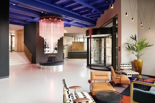 a lobby with blue ceilings and chairs and a chandelier at Malmaison York in York