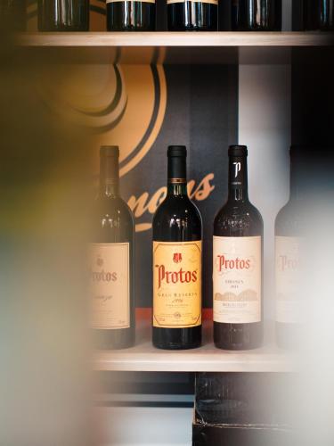three bottles of wine sitting on a shelf at Hotel Los Toreros in Tordesillas