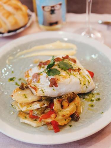a white plate of food with an egg on top at Hotel Los Toreros in Tordesillas