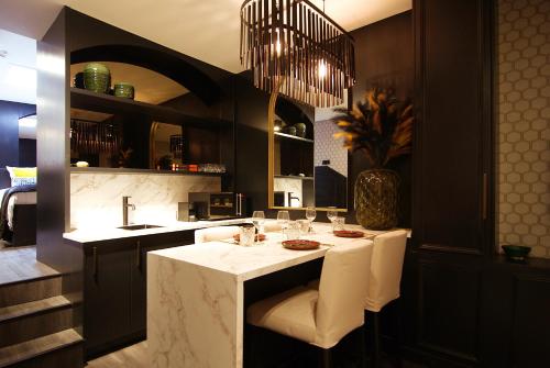 a kitchen with a table with white chairs at House of Freddy in Amsterdam