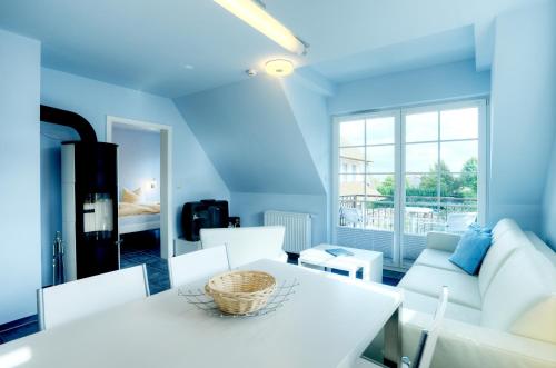 a living room with a white table and chairs at Villa Obendtied, FW 4 in Zingst