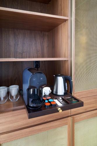 a coffee maker on a shelf in a cupboard at Rio da Vila in Porto