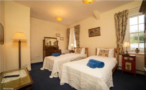 Postel nebo postele na pokoji v ubytování Ravenscliffe Lodge