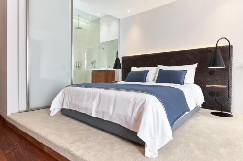 a bedroom with a large bed with a large mirror at Rio da Vila in Porto