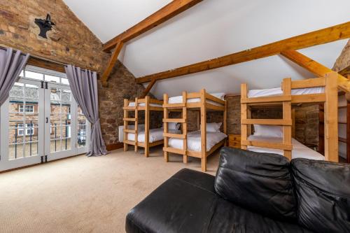 a living room with bunk beds and a couch at Muncaster Castle Coachman's Quarters in Ravenglass