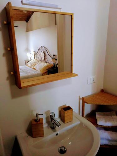 a bathroom with a sink and a mirror at Il Pettirosso in Castellamonte