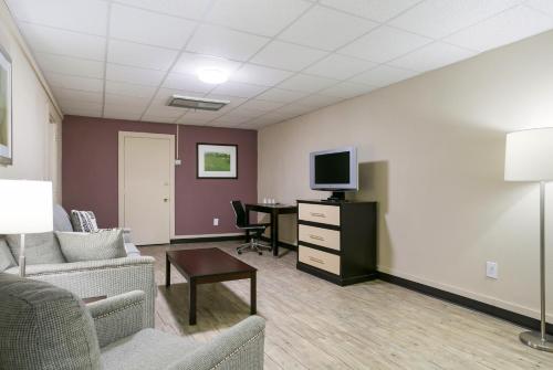 a living room with a couch and a tv and a table at Eisenhower Hotel and Conference Center in Gettysburg