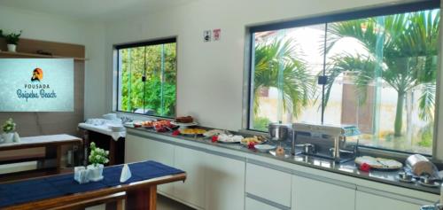 a kitchen with a counter with food on it at Pousada Boipeba Beach in Ilha de Boipeba