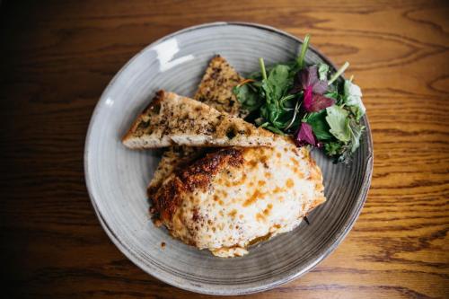 a plate of food with a sandwich and a salad at Three Horseshoes Inn in Hereford