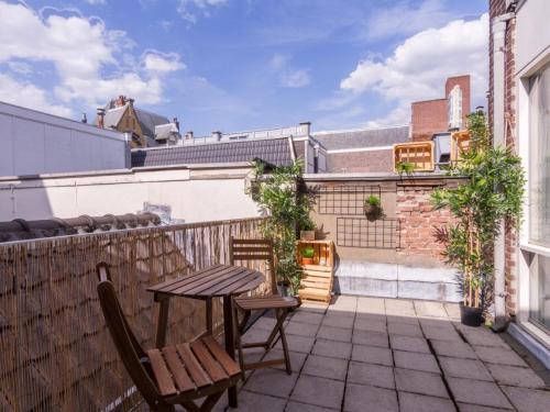 a patio with a table and two chairs on a balcony at Pink Flamingo Boutique Hostel in The Hague