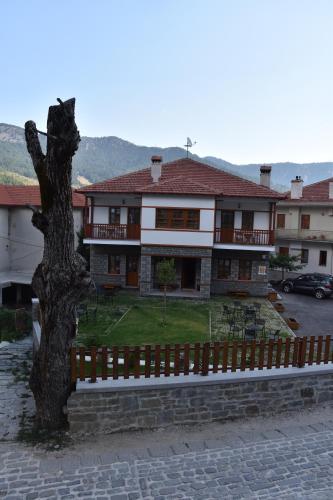 a large house with a fence in front of it at NUCA GUESTHOUSE in Metsovo