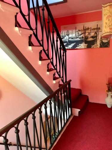 a staircase in a house with red walls at Alloggi Serena in Venice