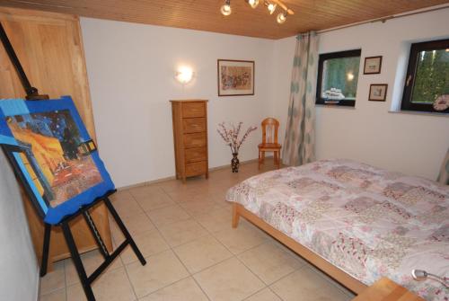 a bedroom with a bed and a painting on a easel at Ferienwohnung Strandperle in Heiligenhafen