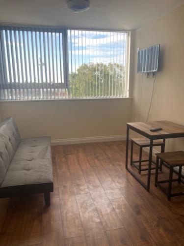 a living room with a couch and a table at Nantwich House in Crewe