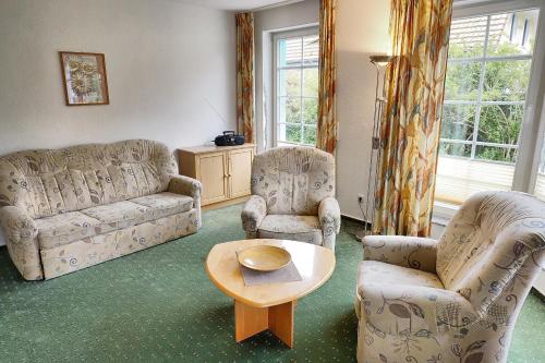 a living room with two couches and a table and chairs at An der Galerie, B 06 in Zingst