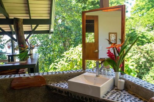 a bathroom with a sink and a mirror at Tiskita Jungle Lodge in Pavones
