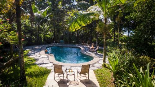 a swimming pool in the middle of a garden at Tiskita Jungle Lodge in Pavones