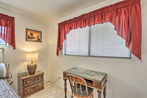a bedroom with a desk and a window with red curtains at Bisbee Home Less Than half Mi to Park and Tennis Courts! in Bisbee