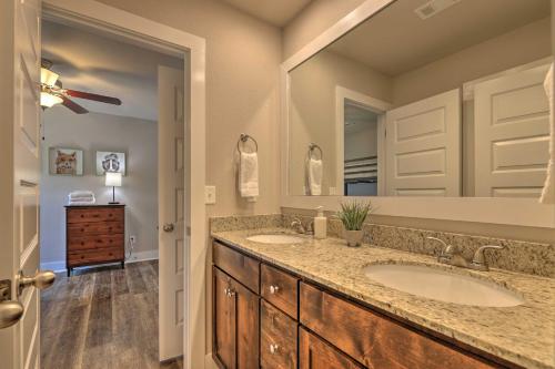 a bathroom with two sinks and a large mirror at Fayetteville House Pool Access and Gas Grill! in Fayetteville