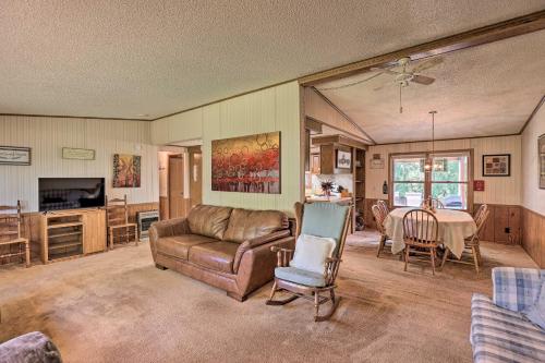 a living room with a couch and a table at Charming Burdett Home with Grill, Gazebo and Yard in Burdett