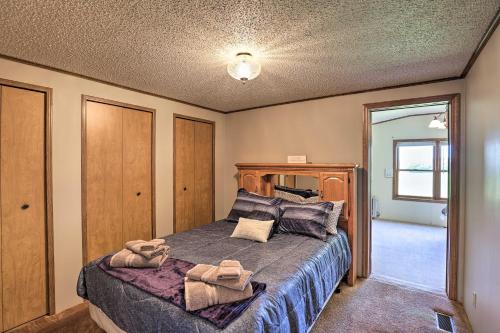 a bedroom with a bed with a wooden head board at Charming Burdett Home with Grill, Gazebo and Yard in Burdett