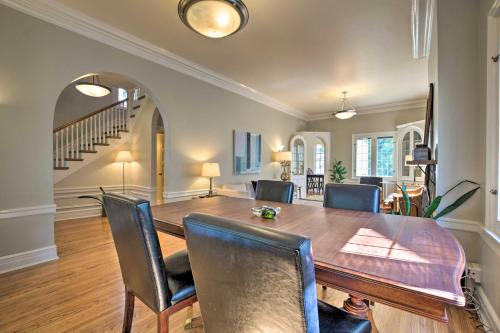 a dining room with a wooden table and chairs at Classic Oak Park Home, 11 Mi to Downtown Chicago! in Oak Park