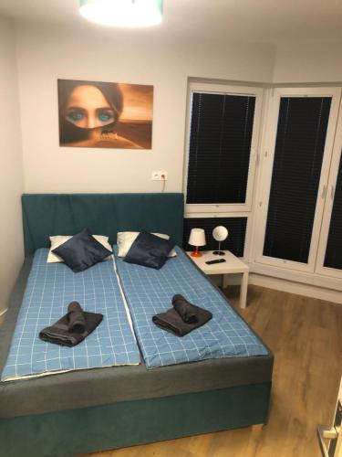 a bedroom with a bed with two hats on it at Klimatyzowany Apartament EGIPT z sauną i miejscem parkingowym in Kielce