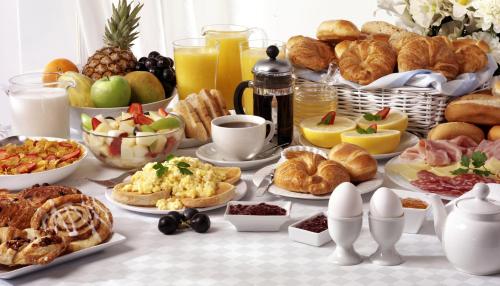 a breakfast table with croissants and other breakfast foods at Hotel Hansehof in Hamburg