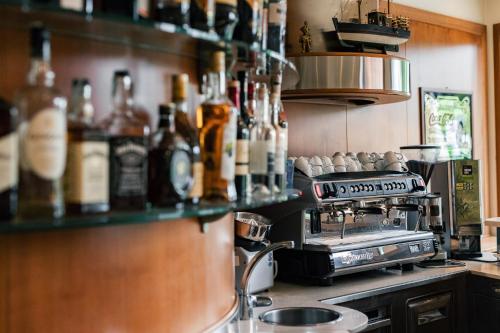 a kitchen with a counter with a stove and bottles at Hotel Crystal in Preganziol