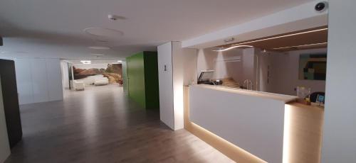 a living room with green and white walls at Hotel Azahar in Murcia
