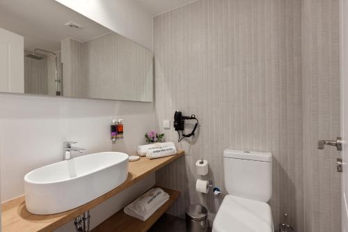 a bathroom with a white sink and a toilet at Trendy Hotel by Athens Prime Hotels in Athens