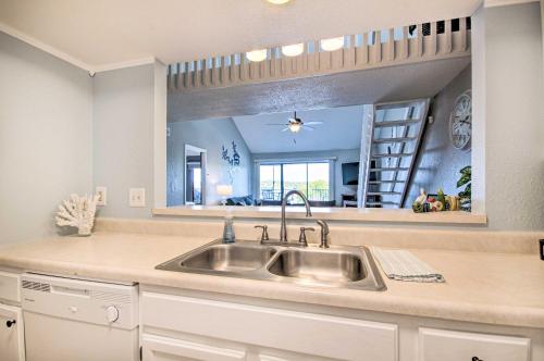 a kitchen with a sink and a large mirror at Waterfront Ozark Gem with Pool Access and Lake Views! in Lake Ozark