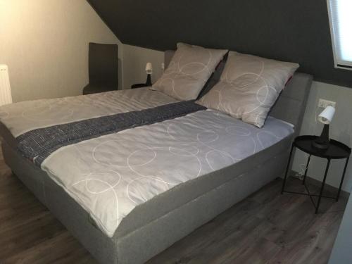 a bed with white sheets and pillows in a bedroom at HeuStadl in Tauberbischofsheim