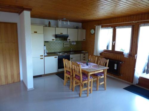 a kitchen with a table and chairs in a room at Ferienhaus Rombach Wohnung C in Wieden