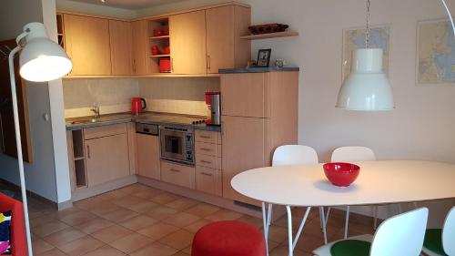 a kitchen with a table and a table and chairs at Seestraße 71 Ap 7 in Zingst