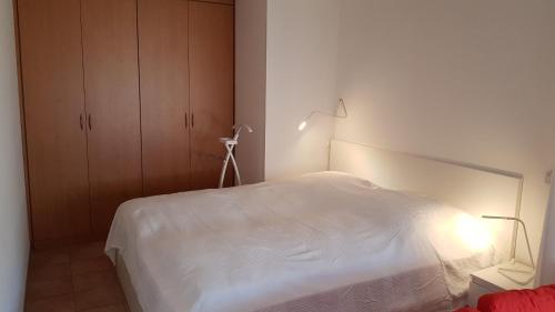 a bedroom with a white bed and a lamp at Seestraße 71 Ap 7 in Zingst
